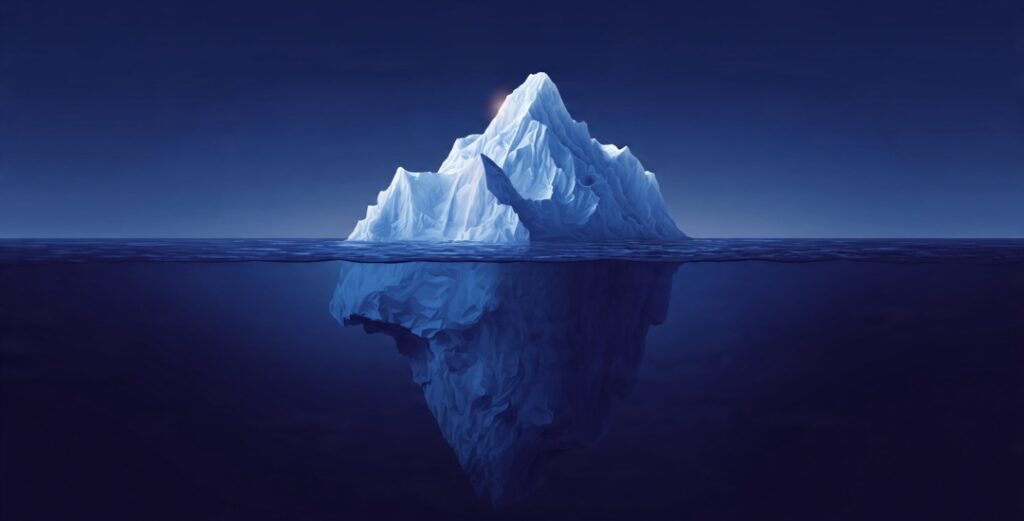 An iceberg showing a small flashy appearance of wealth above water and vast hidden real wealth below, illustrating stealth wealth.